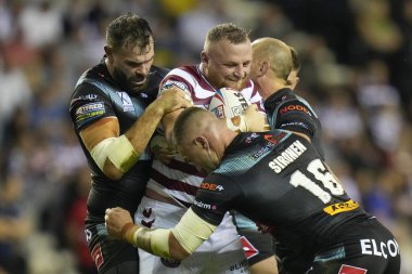 Curtis Sironen #16 and Alex Walmsley of St Helens tackle Brad Singleton #8 of Wigan Warriors