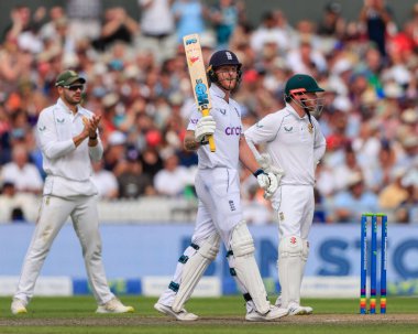 Ben Stokes of England raises his bat as he reaches fifty runs