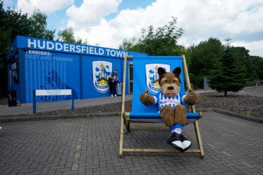 The Huddersfield Town mascot sits outside the Stadium greeting fans before the game 