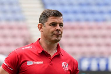 St Helens coach Paul Wellens inspects the pitch before the game 