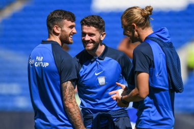 Preston North End players share a joke pre match pitch inspection