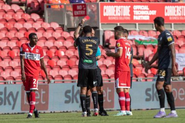 Referee Robert Madley awards a red card to Ben Cabango #5 of Swansea City during the second half 