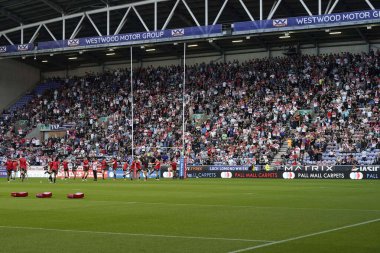 St Helens players warm up in front of the North Stand packed with Saints fans