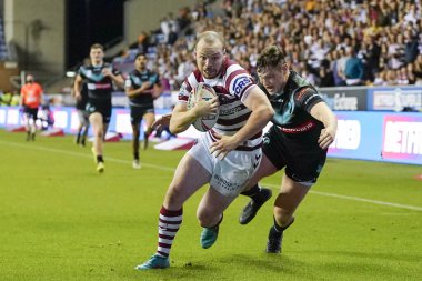 Liam Marshall #5 of Wigan Warriors dives for the try line to score