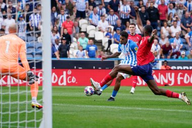 Tino Anjorin #8 of Huddersfield Town drives home his second goal past Dave Button #1 of West Bromwich Albion 