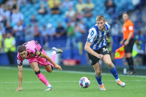 Mark McGuinness #34 of Sheffield Wednesday gets past Corey O'Keeffe #2 of Forest Green Rovers