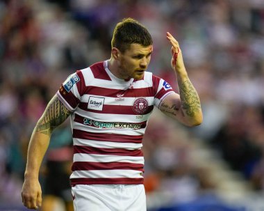 John Bateman #13 of Wigan Warriors needs treatment for a cut head