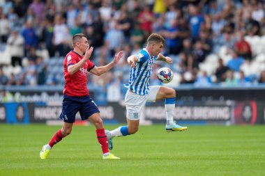 Josh Ruffels #14 of Huddersfield Town controls the ball 