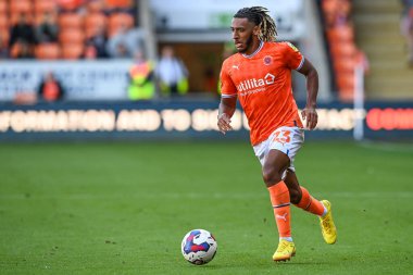 Dominic Thompson #23 of Blackpool makes a break with the ball
