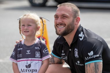 Josh Griffin #4 of Hull FC has his picture taken with a young Hull FC supporter ahead of today's game 