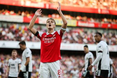 Martin degaard #8 of Arsenal tries to get the crowd going  