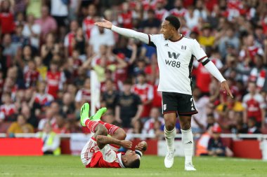 Kenny Tete #2 of Fulham gestures to the referee with Gabriel Jesus #9 of Arsenal left on the floor 