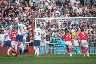 Dean Henderson #1 of Nottingham Forest saves a penalty from Harry Kane #10 of Tottenham Hotspur 