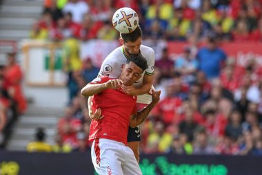 Ben Davies #33 of Tottenham Hotspur and Brennan Johnson #20 of Nottingham Forest battle for the ball 