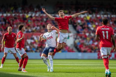 Harry Kane #10 of Tottenham Hotspur knocks Ryan Yates #22 of Nottingham Forest off the ball