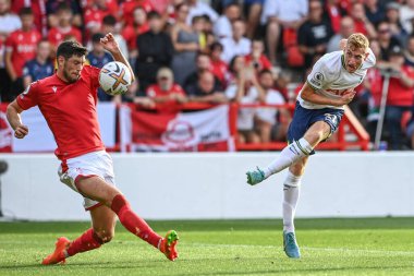 Dejan Kulusevski #21 of Tottenham Hotspur shoots on goal as Scott McKenna #26 of Nottingham Forest tries to block 