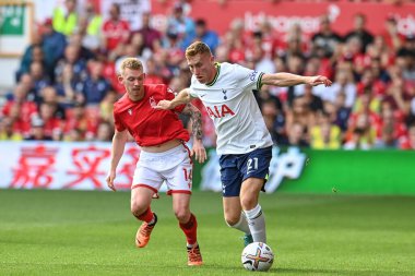 Dejan Kulusevski #21 of Tottenham Hotspur holds off Lewis O'Brien #14 of Nottingham Forest 
