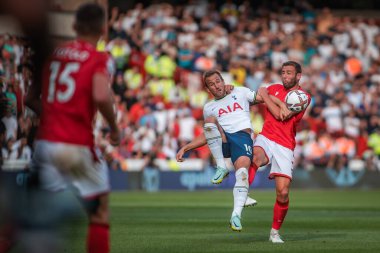 Harry Kane #10 of Tottenham Hotspur beats Steve Cook #3 of Nottingham Forest to the ball 