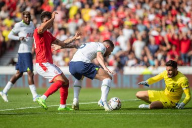 Pierre-Emile Hjbjerg #5 of Tottenham Hotspur shields the ball from Brennan Johnson #20 of Nottingham Forest  