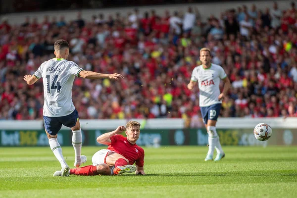 Ryan Yates #22 of Nottingham Forest beats Ivan Perii #14 of Tottenham Hotspur into a challenge 