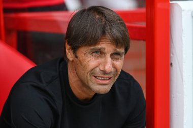 Antonio Conte manager of Tottenham Hotspurs takes his seat in the dugout