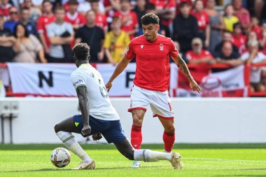 Morgan Gibbs-White #10 of Nottingham Forest is tackled by Davinson Snchez #6 of Tottenham Hotspur 