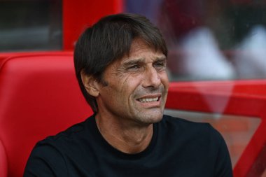 Antonio Conte manager of Tottenham Hotspurs takes his seat in the dugout
