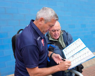 Daryl Powell Head Coach of Warrington Wolves signs autographs as he arrives at the Stadium
