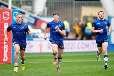 Jason Clark, Riley Dean and Jake Wardle of Warrington Wolves warm up before the match 