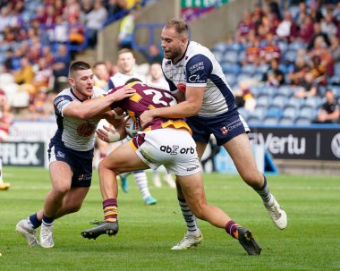 Danny Walker #16 and James Harrison of Warrington Wolves tackle Louis Senior #22 of Huddersfield Giants