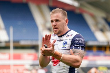 Matt Dufty #36 of Warrington Wolves applauds the travelling Wire fans after the match 