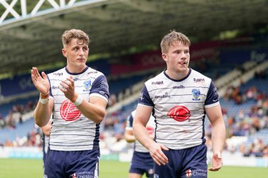 Josh Lynch and Luke Thomas of Warrington Wolves applaud the travelling Wire fans after the match 