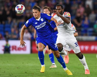 Perry Ng #38 of Cardiff City  Under pressure from Cameron Jerome #35 of Luton Town 