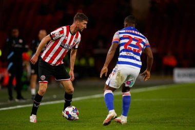 Chris Basham #6 of Sheffield United  and Junior Hoilett #23 of Reading during the Sky Bet Championship match Sheffield United vs Reading at Bramall Lane, Sheffield, UK, 30th August 2022