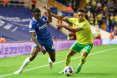 Josh Williams #48 of Birmingham City dribbles the ball whilst under pressure from  Aaron Ramsey #20 of Norwich City