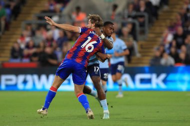 Ivan Toney #17 of Brentford and Joachim Andersen #16 of Crystal Palace tussle off the ball.