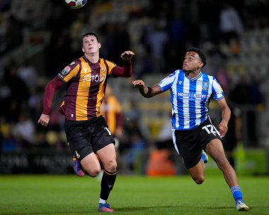 Matty Foulds #14 of Bradford City and Leojo Davidson of Sheffield Wednesday chase a loose ball