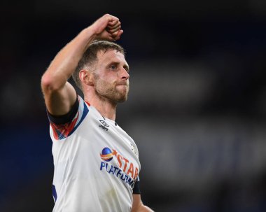 Jordan Clark #18 of Luton Town salutes the travelling supporters