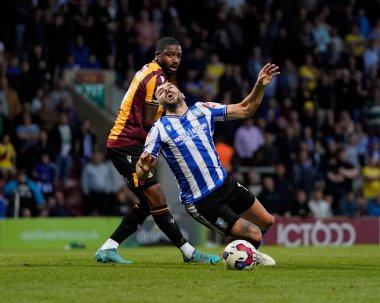 Yann Songo'o #4 of Bradford City fouls Callum Paterson #13 of Sheffield Wednesday in the box for a penalty 