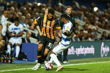 Cyrus Christie #33 of Hull City and Kenneth Paal #22 of QPR tussle for the ball