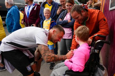 Jack Hunt #32 of Sheffield Wednesday signs an autograph for a young fan before the game 