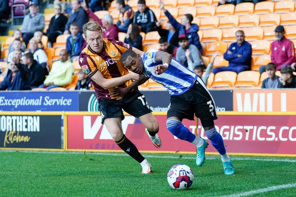 Luke Hendrie #17 of Bradford City holds back Jaden Brown #3 of Sheffield Wednesday 