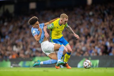 Lewis O'Brien #14 of Nottingham Forest looks to shrug off Nico Lewis #82 of Manchester City