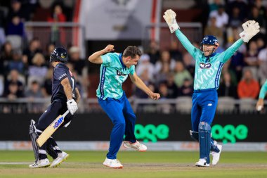 Peter Hatzoglou of Oval Invincibles celebrates with Sam Billings after taking the wicket of Laurie Evans of Manchester Originals