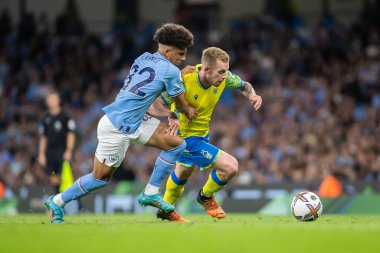 Lewis O'Brien #14 of Nottingham Forest looks to shrug off Nico Lewis #82 of Manchester City