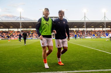 Josh Bowler #11 and Kenny Dougall #12 of Blackpool leave the field at the end of the pre-game warmup