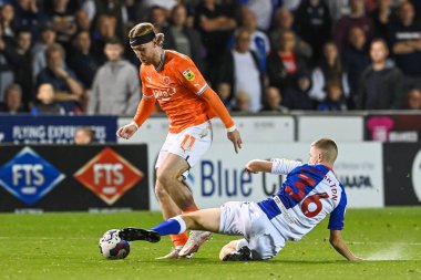 Josh Bowler #11 of Blackpool is tackled by Adam Wharton #36 of Blackburn Rovers clipart