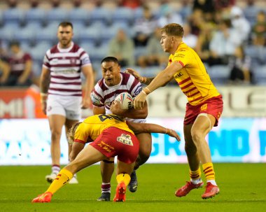 Willie Isa #11 of Wigan Warriors is tackled during the Betfred Super League match Wigan Warriors vs Catalans Dragons at DW Stadium, Wigan, United Kingdom, 2nd September 202
