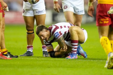 Cade Cust #6 of Wigan Warriors winces in pain as he holds his elbow after a tackle during the Betfred Super League match Wigan Warriors vs Catalans Dragons at DW Stadium, Wigan, United Kingdom, 2nd September 202