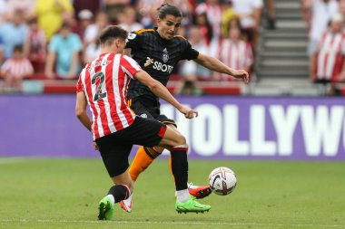 Pascal Struijk #21 of Leeds United and Aaron Hickey #2 of Brentford challenge for the ball during the Premier League match Brentford vs Leeds United at Brentford Community Stadium, London, United Kingdom, 3rd September 202
